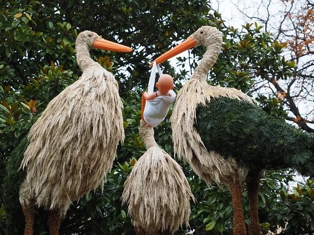 Storchfiguren mit einem Baby als Symbolbild zum Kinderwunsch